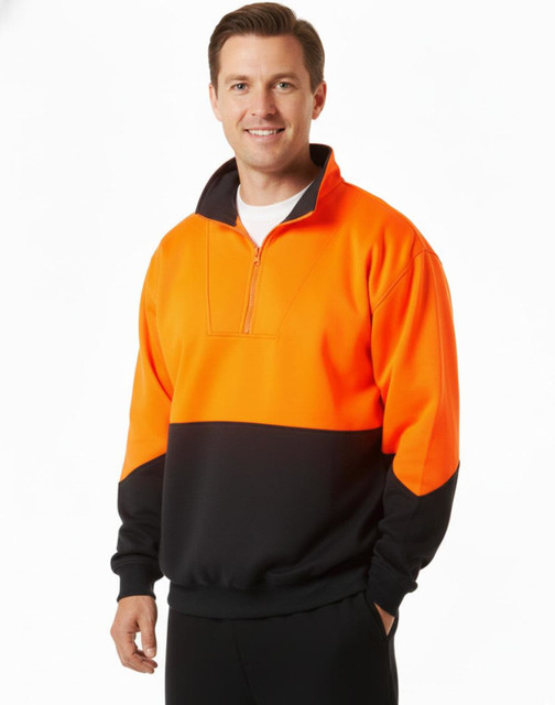 A high-visibility long-sleeve windcheater collar in orange and black, worn by a smiling man. The design includes a zip and a logo.