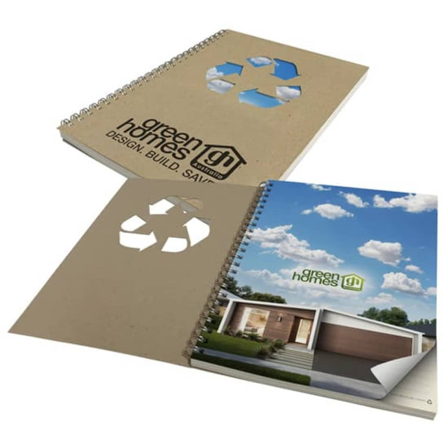 A brown recycled notebook with a spiral binding, featuring an eco-themed design and a logo on the cover.