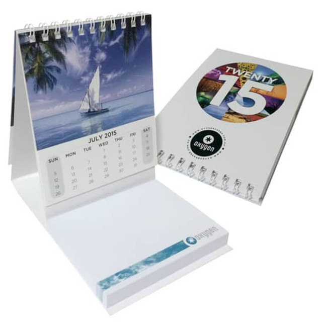 A promotional mini calendar featuring a scenic sailboat image and a colourful design, with a white spiral binding.