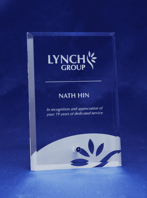 A clear glass rectangular award with a laser-engraved design and a logo at the top. A clear glass rectangular award with a laser-engraved design and a logo at the top.