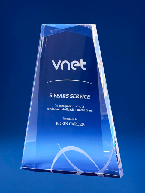 A crystal award with a multi-faceted design in clear and blue, featuring a logo and engraved text. A crystal award with a multi-faceted design in clear and blue, featuring a logo and engraved text.