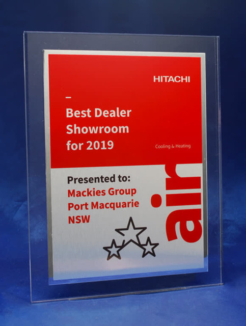 A clear acrylic plaque features a brushed metal plate with a shiny border, showcasing a prominent logo and award details. A clear acrylic plaque features a brushed metal plate with a shiny border, showcasing a prominent logo and award details.