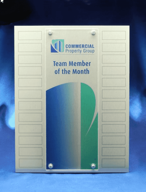 A perpetual award with a metallic finish and acrylic overlay, featuring a logo and multiple printed plates for names. A perpetual award with a metallic finish and acrylic overlay, featuring a logo and multiple printed plates for names.