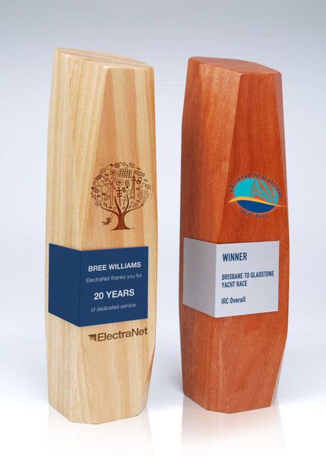 Two wooden trophies made of light and dark timber with engraved designs and metal wraps, showcasing a winner's title. Two wooden trophies made of light and dark timber with engraved designs and metal wraps, showcasing a winner's title.