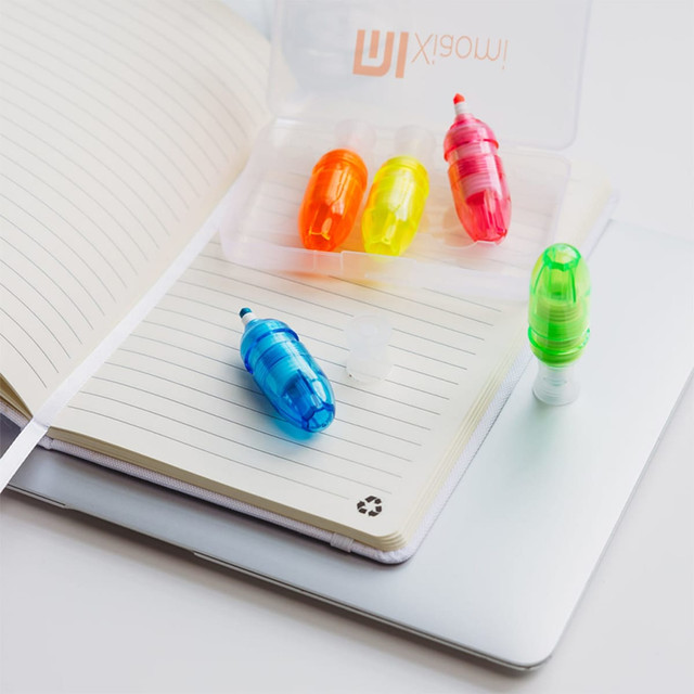 Mackie highlighter set featuring vibrant blue, green, yellow, and orange highlighters in a clear case on a notebook.