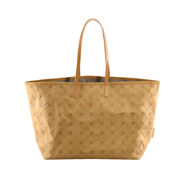 A kraft paper tote bag in a warm yellow hue, featuring a subtle logo pattern and tan handles. A kraft paper tote bag in a warm yellow hue, featuring a subtle logo pattern and tan handles.