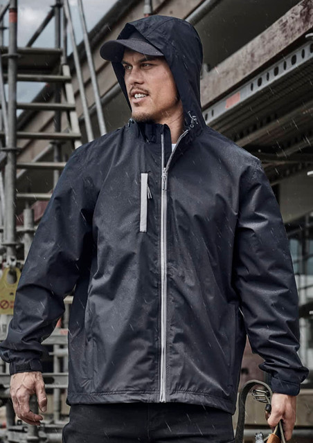 A unisex super light packable rain jacket in black, featuring a hood and zippered pocket, against a construction backdrop.
