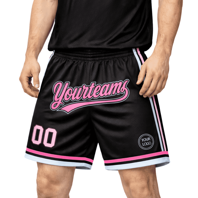 A pair of black basketball shorts with pink accents, featuring a logo and text design.