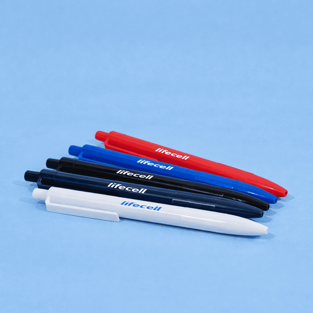 A collection of plastic ball pens in black, blue, red, and white, featuring branding on each pen.