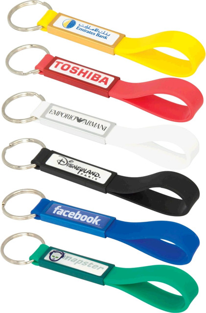 A collection of silicone sling keyrings in various colours, featuring different branding and a dome-indent design.