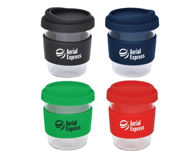 A set of reusable coffee cups in black, green, red, and clear, each with a silicone band and a logo.
