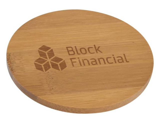 A round bamboo coaster with a light brown finish, featuring a logo engraved on its surface.