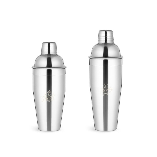 A stainless steel cocktail shaker in shiny silver, featuring a sleek design and a logo. Two pieces included. A stainless steel cocktail shaker in shiny silver, featuring a sleek design and a logo. Two pieces included.