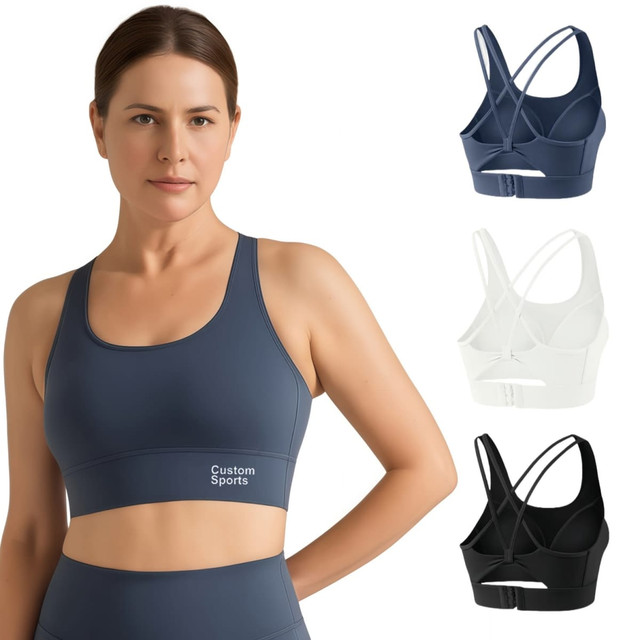 A women's cross back yoga crop bra tank in navy blue, white, and black, featuring a logo.