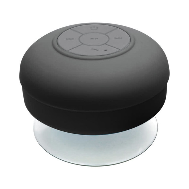 A waterproof black Bluetooth speaker with a circular design and control buttons on top. It features a clear base.