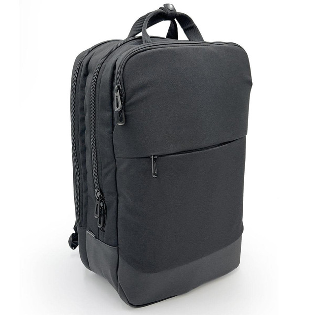 A sleek black laptop bag with multiple zippers and a front pocket, featuring a minimalist design and branding.
