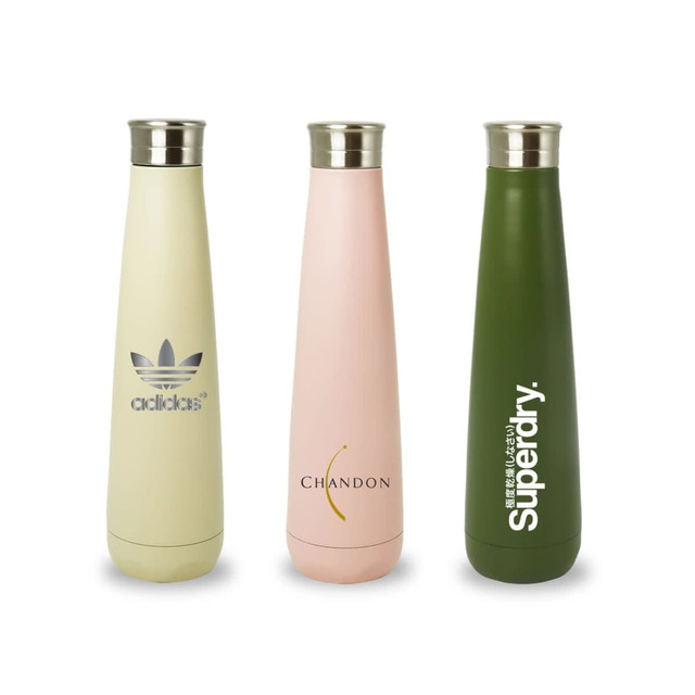 A drink bottle trio featuring a pale green, pink, and olive green water bottle, each with a metallic cap and logo.
