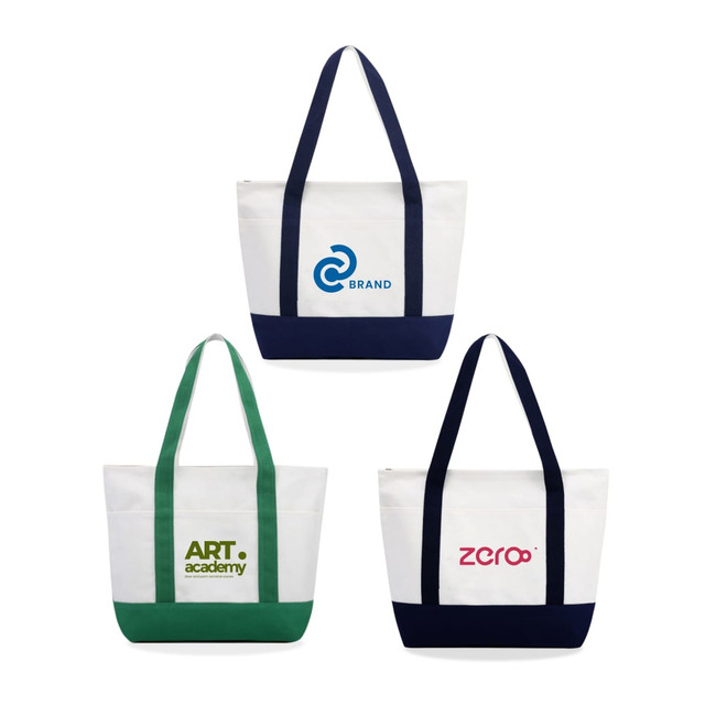 Three medium canvas tote bags in white with navy and green accents, featuring logos on the front.