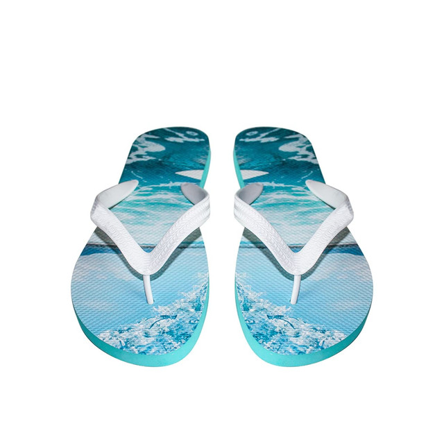 A pair of rubber thongs featuring a blue water design and white straps, with a logo on the sole.