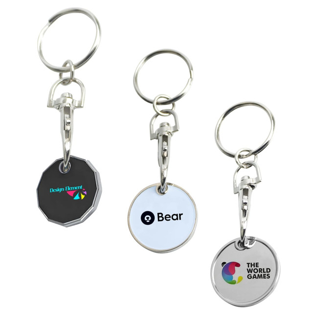 Three printed trolley coin keyrings in various shapes, featuring different logos. The keyrings have silver keychains.