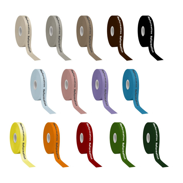 A collection of screen printed satin polyester ribbons in various colours, including brown, pink, purple, yellow, and green. Each ribbon features branding.