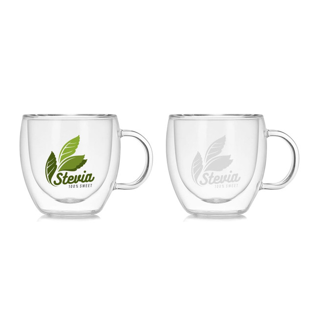 A double wall glass mug in clear, featuring a handle and a logo with green leaves. Two mugs are displayed side by side.
