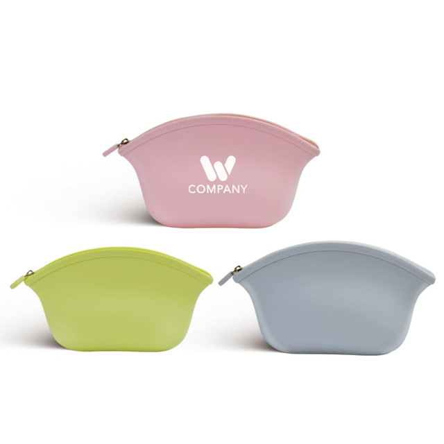 A set of silicone cosmetic bags in pink, green, and blue, each with a simple logo.