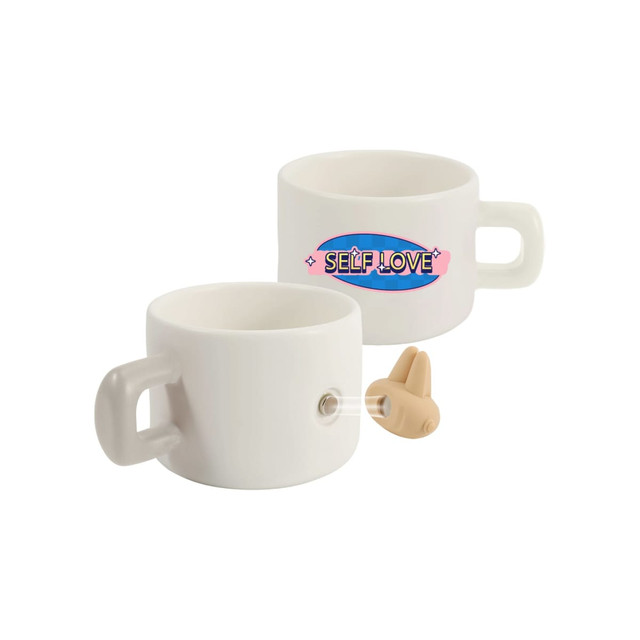 A white ceramic mug with a handle, featuring a logo and a small silicone accessory.