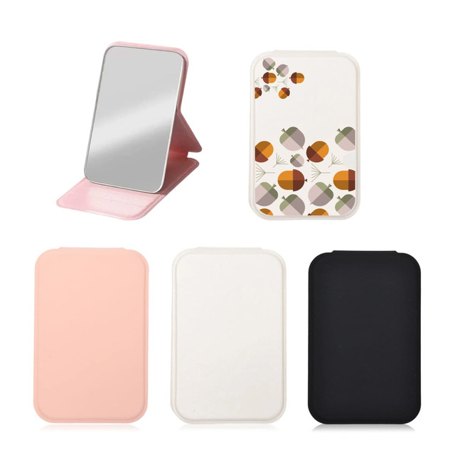 A portable mini mirror set featuring a pink, white, and black design, with one mirror displaying a floral pattern.