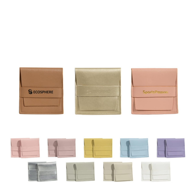 A collection of PU leather flip jewellery pouches in various pastel colours, featuring discreet logos on some.