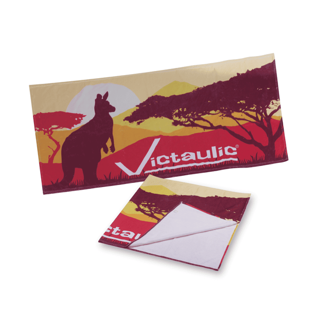 A sublimated beach towel featuring vibrant red, yellow, and orange colours with a kangaroo silhouette and a logo.