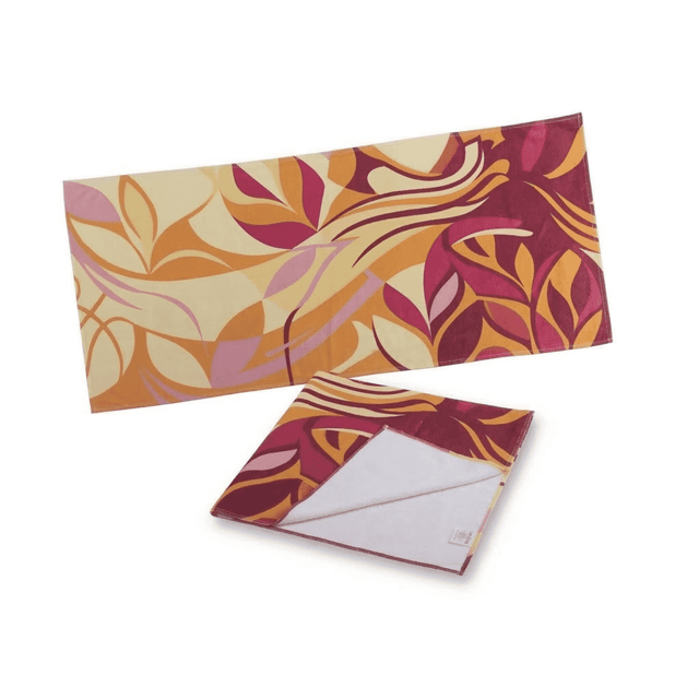 A patterned sports towel featuring shades of pink, orange, and cream, also displaying an inner side in white.