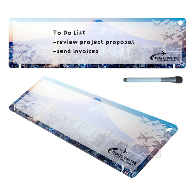 A dry erase board featuring a blue and white design with a mountain and city skyline, along with a marker.