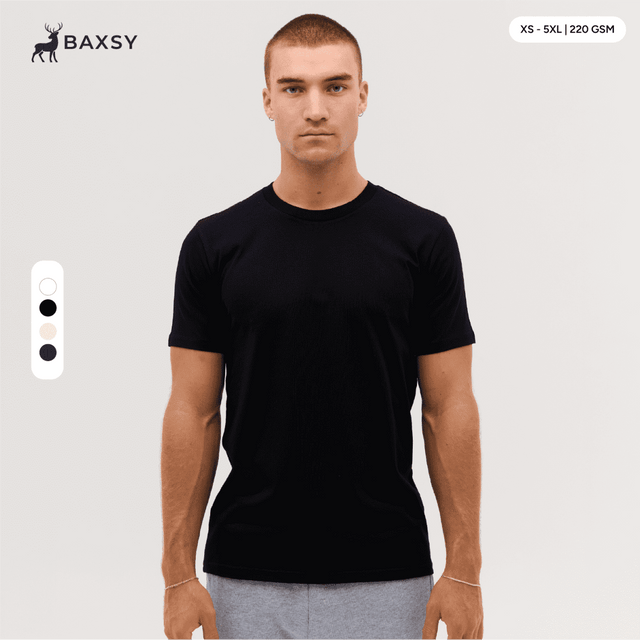 A model wearing a black Classic Tee. The tee features a simple design and has a logo on it.