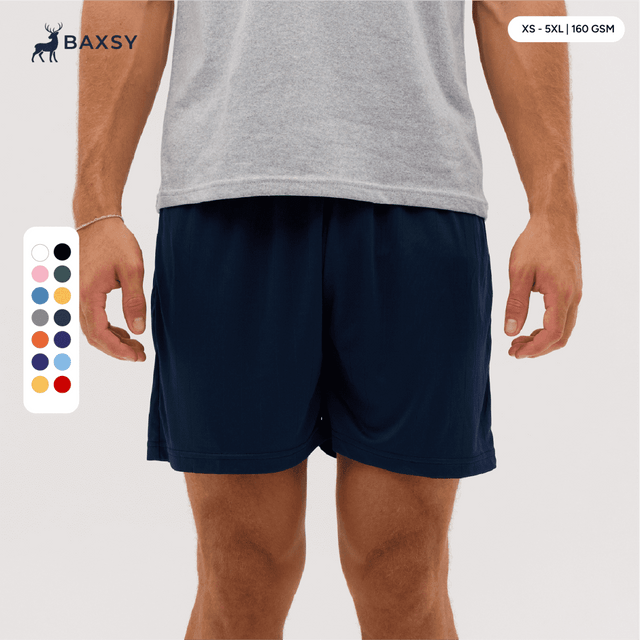 Navy shorts displayed on a model, featuring an elastic waistband and side pockets. Includes a colour selection chart.