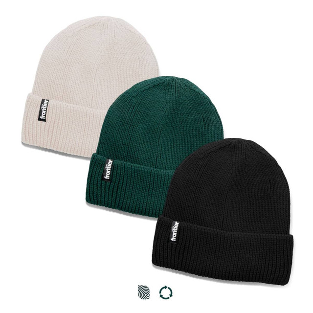 Three beanies in cream, green, and black, featuring a logo on the front. Each has a ribbed design.
