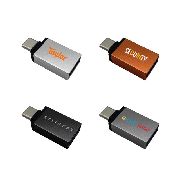 A collection of four USB data blockers in silver, orange, and black with various branding logos.