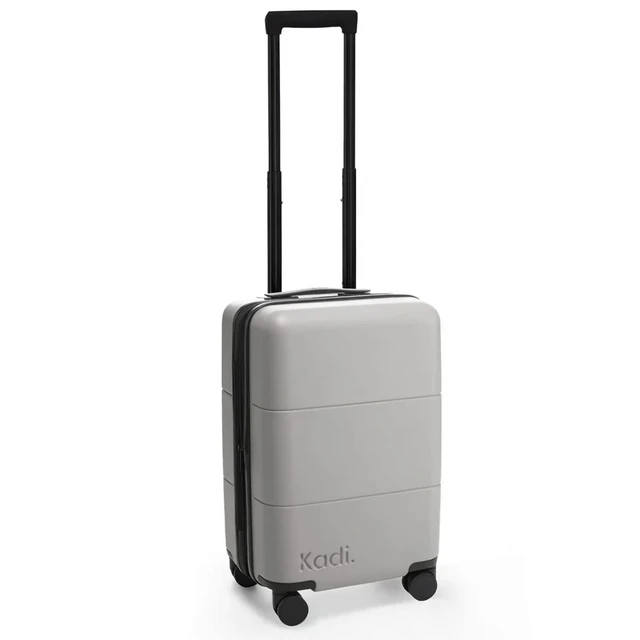 A grey carry-on suitcase with four wheels and a retractable handle, featuring branding on the side.