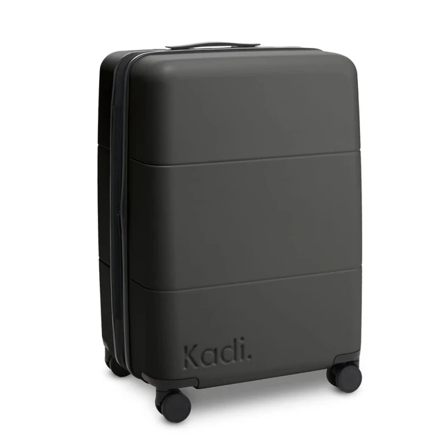 A medium suitcase in black with a textured surface and four wheels, featuring a logo.