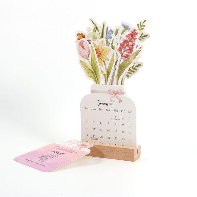 A desk calendar featuring a floral design with pink and yellow flowers, set in a wooden holder.