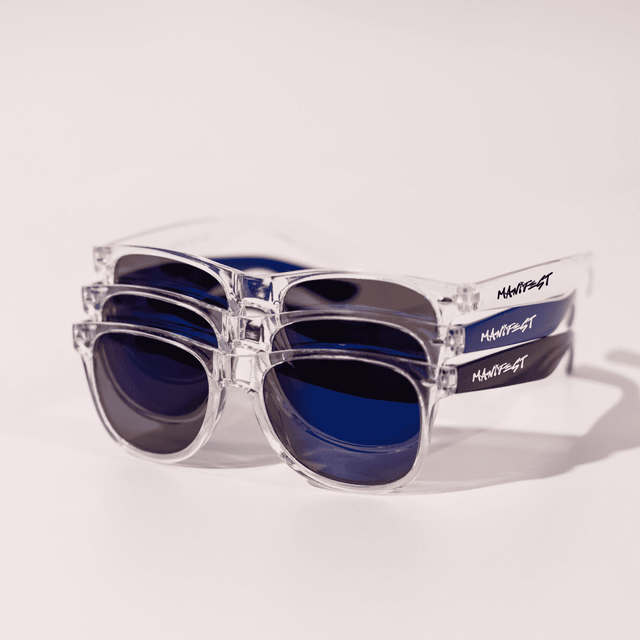A pair of clear and blue sunglasses stacked on top of each other, featuring a logo on the side.