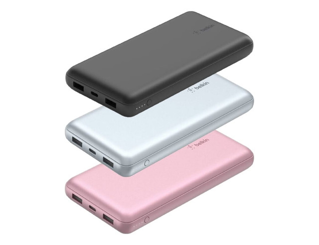 A stack of three power banks in black, silver, and pink, featuring multiple USB ports and a logo.