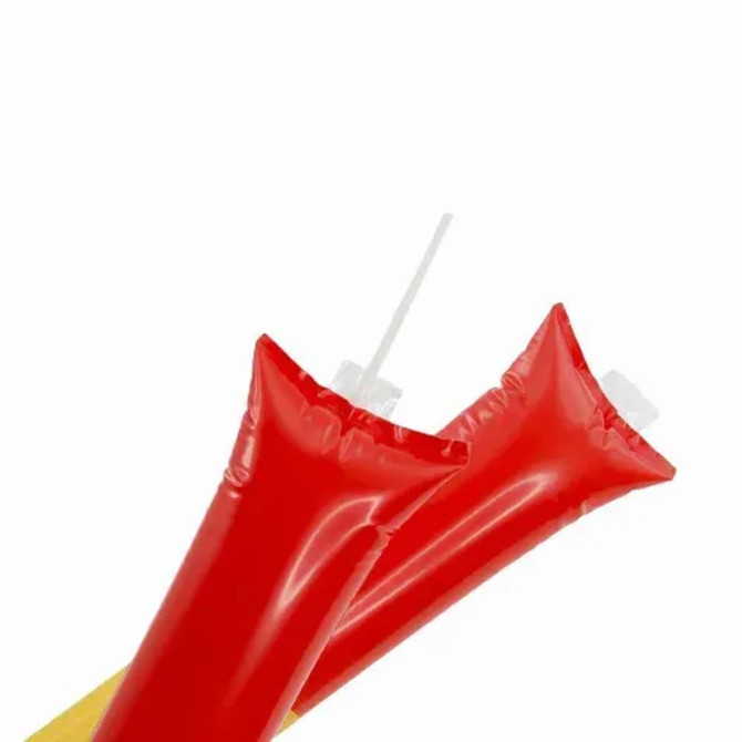 Two inflatable red condiment bottles with white lids and straw openings.