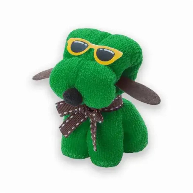 A green dog plush toy wearing yellow sunglasses and a brown ribbon around its neck. It has soft, textured fabric.