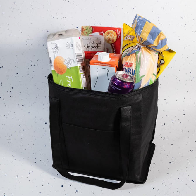 A black cooler bag filled with groceries, including cartons, a drink, and a pack of baked goods.