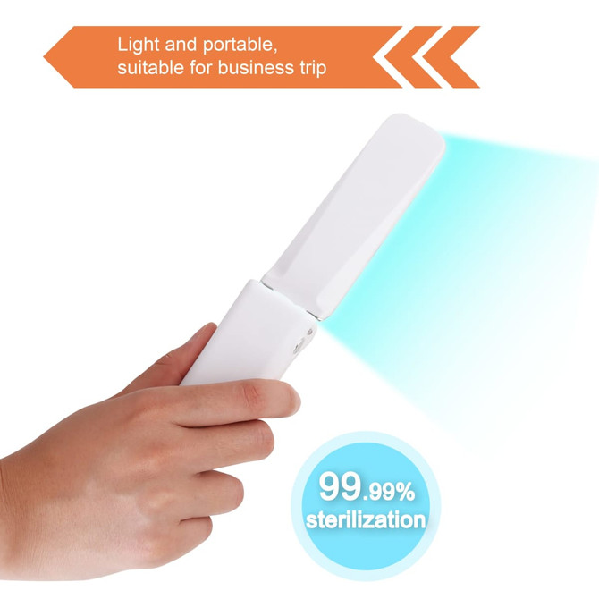A portable UV sterilizer held in a hand, featuring a sleek white design emitting a blue light.
