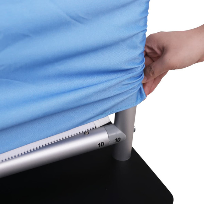 A light blue fabric cover is being adjusted on a grey metal stand with a black base.