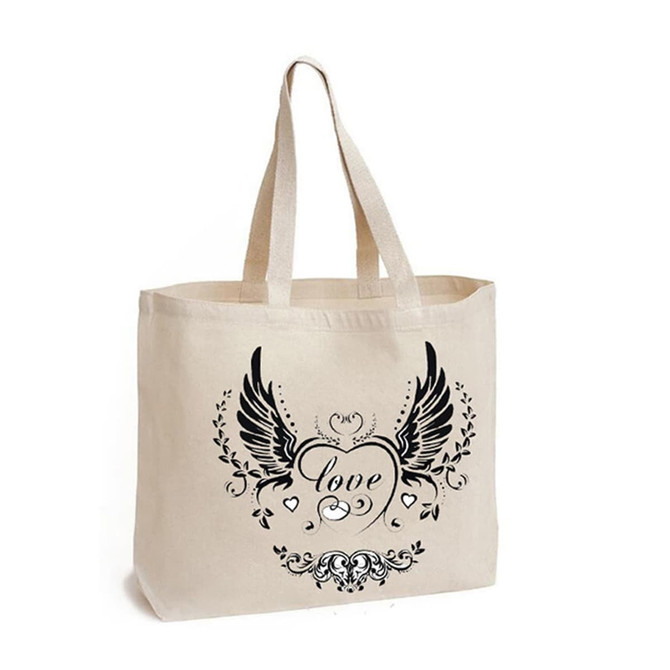 A cream calico bag with a gusset and a decorative black print featuring wings and a heart design. It has two short handles and a logo.