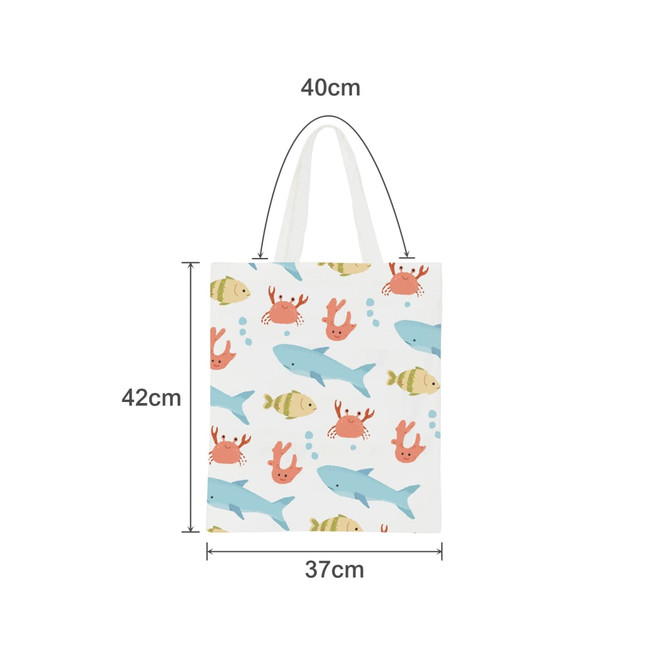 A tote bag featuring a pattern of fish and crabs in pastel colours, with short handles. Measures 40cm by 42cm.