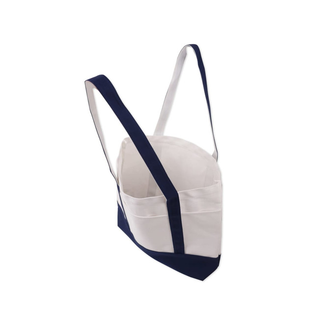 A medium canvas tote bag featuring a white body and navy blue accents, with adjustable straps and a logo.